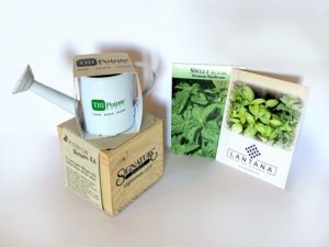 A Blossom kit, watering can, and seeds for a Grand Opening Event