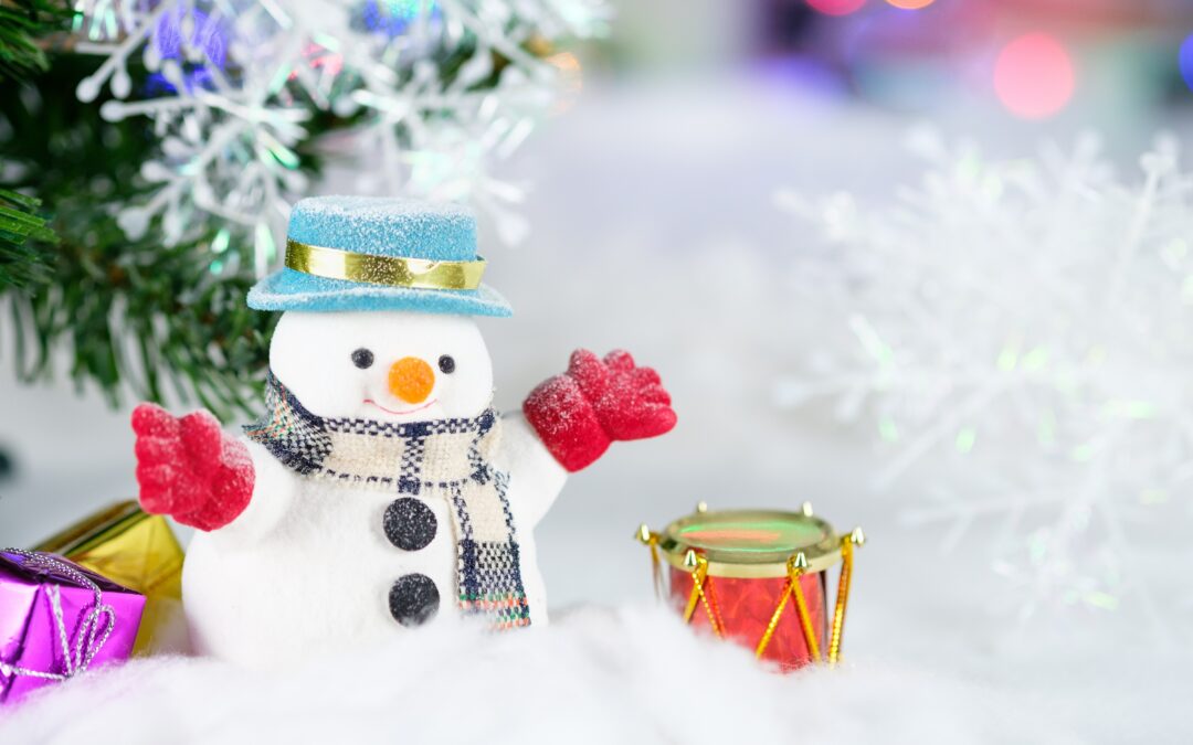 snowman in snow with little drum